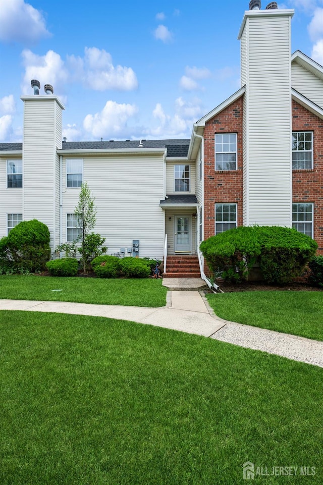 170 Vasser Dr, Piscataway, NJ 08854 - view of property with a chimney, a front yard, and brick siding