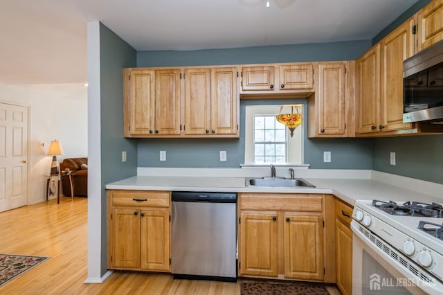 170 Vasser Dr, Piscataway, NJ 08854 - kitchen with stainless steel appliances, light countertops, and light wood-type flooring
