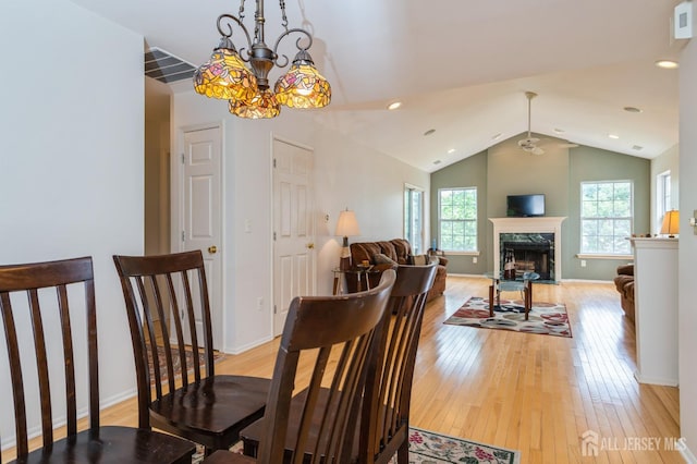 170 Vasser Dr, Piscataway, NJ 08854 - dining space featuring light wood finished floors, a chandelier, lofted ceiling, a premium fireplace, and recessed lighting