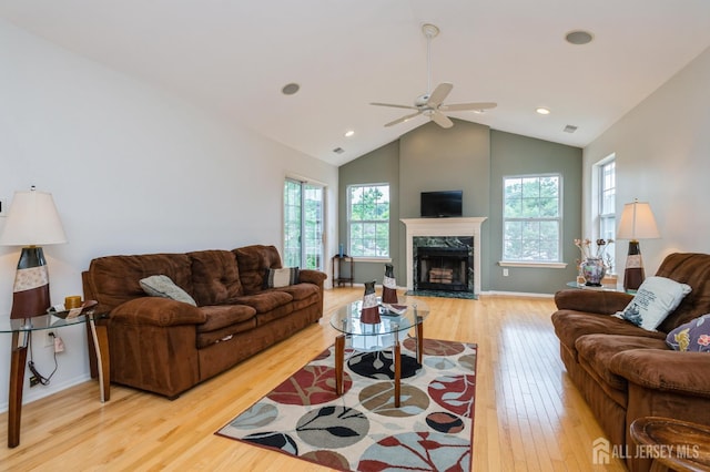 170 Vasser Dr, Piscataway, NJ 08854 - living area with light wood-type flooring, a ceiling fan, plenty of natural light, a fireplace, and high vaulted ceiling