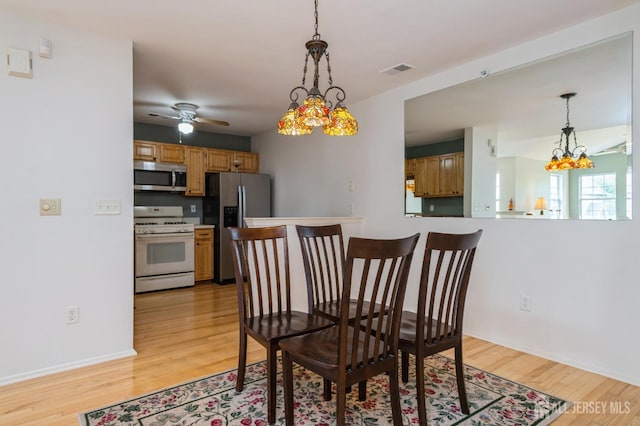 170 Vasser Dr, Piscataway, NJ 08854 - dining space with light wood-style floors, a chandelier, and a ceiling fan