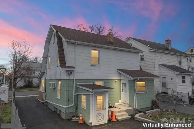 view of back house at dusk