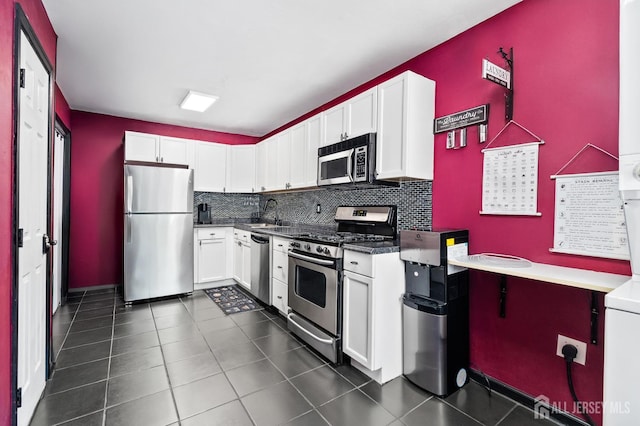 19 Lake Ave Unit 6A, East Brunswick, NJ 08816 - kitchen with stainless steel appliances, white cabinets, tasteful backsplash, and dark tile patterned flooring