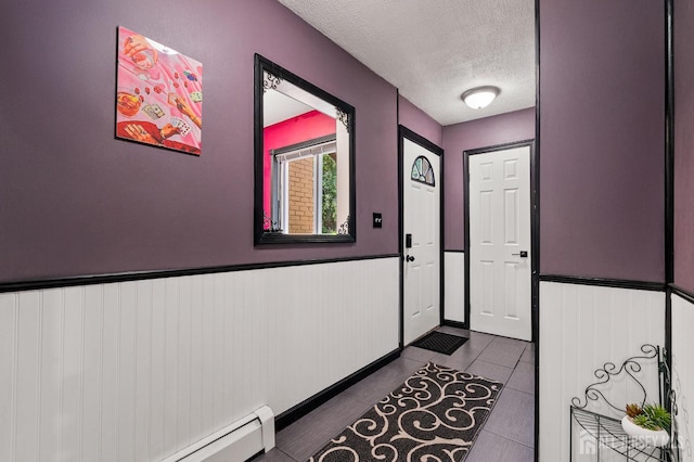 19 Lake Ave Unit 6A, East Brunswick, NJ 08816 - entryway with a textured ceiling, wainscoting, a baseboard radiator, and dark tile patterned flooring