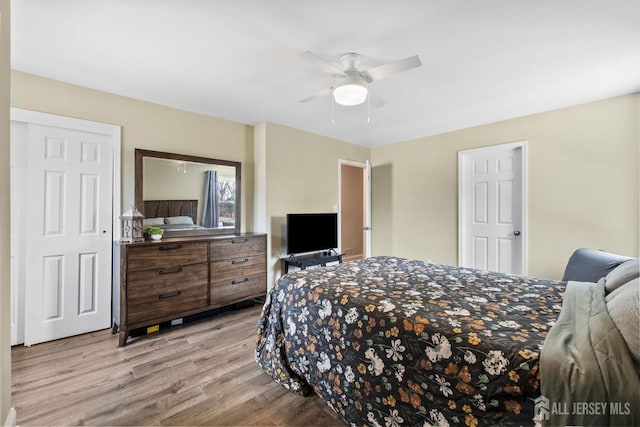 bedroom with light wood-style flooring and a ceiling fan