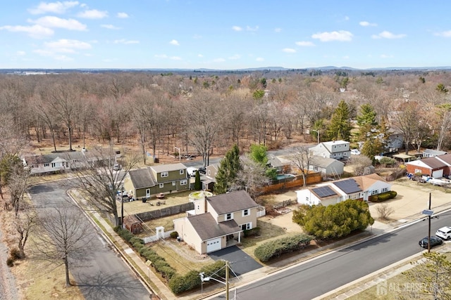 drone / aerial view featuring a view of trees and a residential view