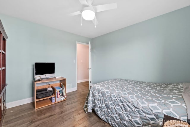 bedroom featuring baseboards, ceiling fan, and wood finished floors