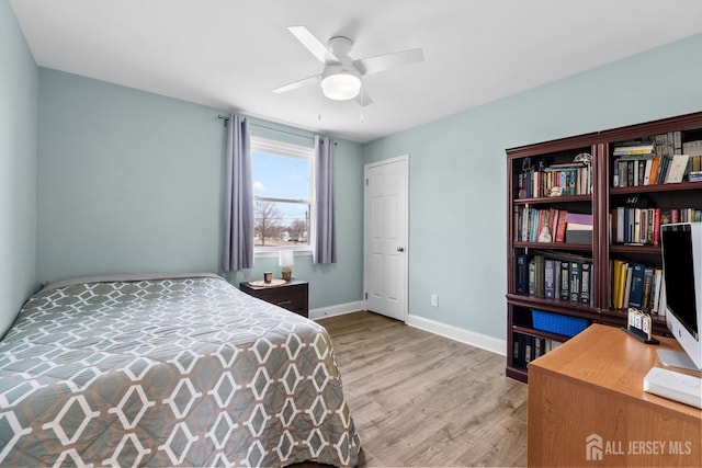 bedroom with light wood-style flooring, ceiling fan, and baseboards