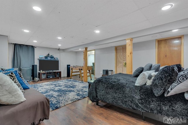 bedroom featuring hardwood / wood-style floors and ornate columns