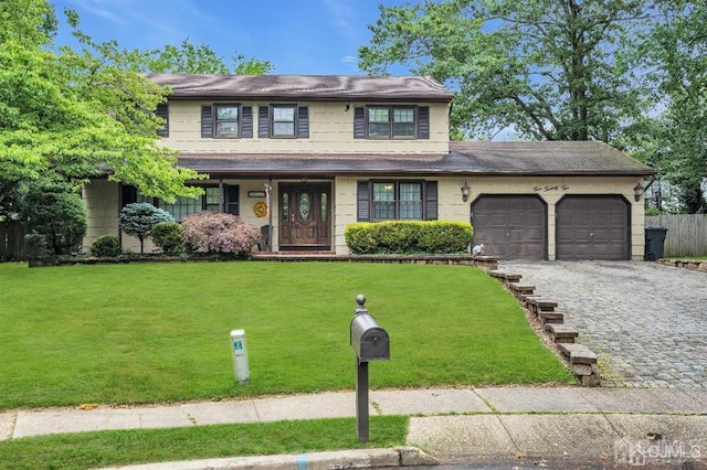 view of front of home with a garage and a front yard