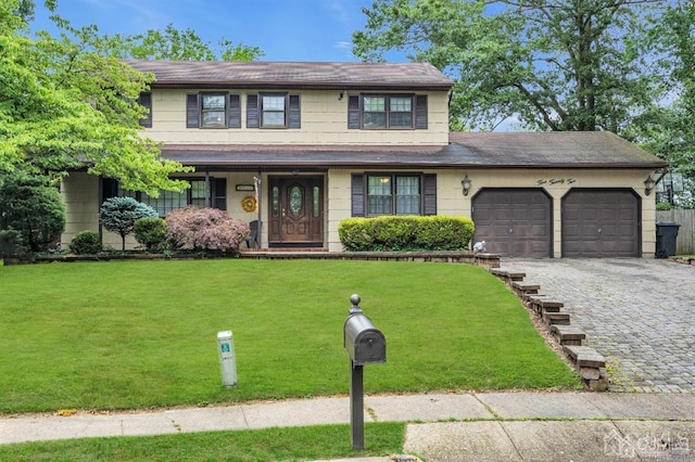 view of front facade with a garage and a front lawn
