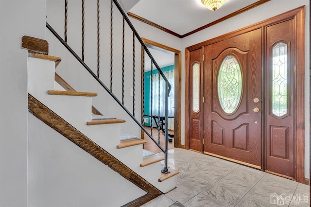 tiled entrance foyer featuring ornamental molding