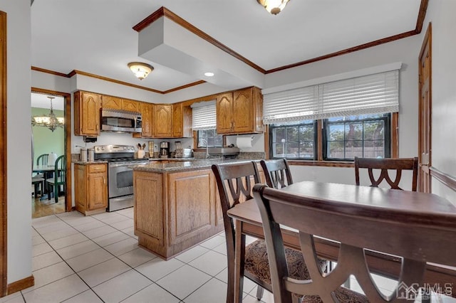 kitchen with light tile patterned flooring, a healthy amount of sunlight, and appliances with stainless steel finishes