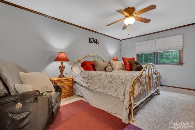 bedroom with carpet flooring, ceiling fan, and crown molding