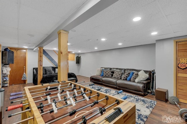 living room with light wood-type flooring and a drop ceiling
