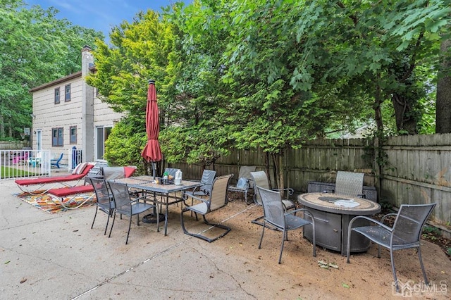 view of patio with a fire pit