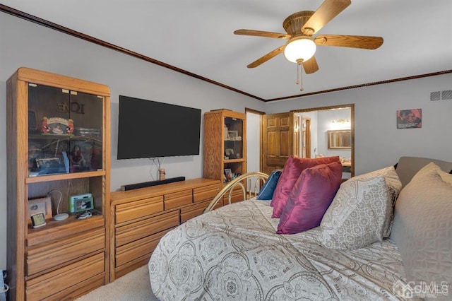 bedroom with ensuite bathroom, carpet flooring, ceiling fan, and crown molding