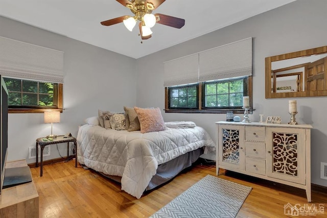 bedroom with light hardwood / wood-style floors and ceiling fan