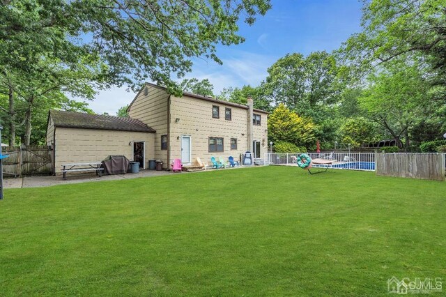 back of property with a lawn