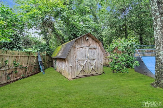 view of outbuilding featuring a lawn