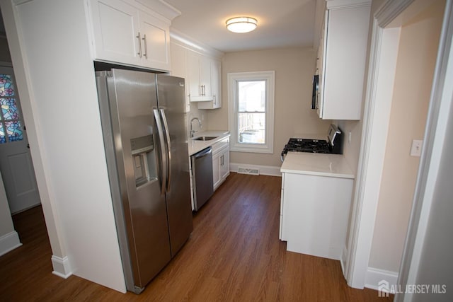 35 Red Bank Rd, Spotswood, NJ 08884 - kitchen with stainless steel appliances, dark wood finished floors, light countertops, and white cabinetry