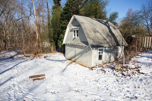 view of snowy exterior featuring an outdoor structure