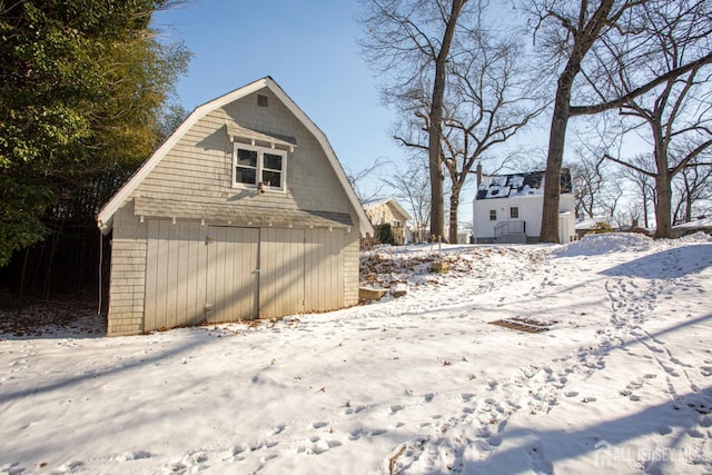 35 Red Bank Rd, Spotswood, NJ 08884 - view of snow covered exterior featuring an outbuilding and a gambrel roof