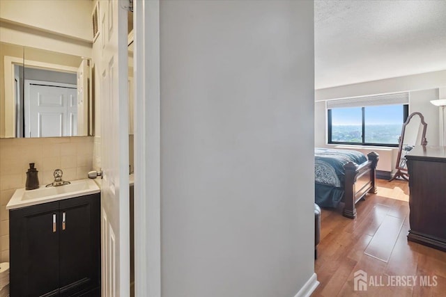 150 Overlook Ave Unit 15E, Hackensack, NJ 07601 - bathroom featuring tasteful backsplash, wood finished floors, and vanity