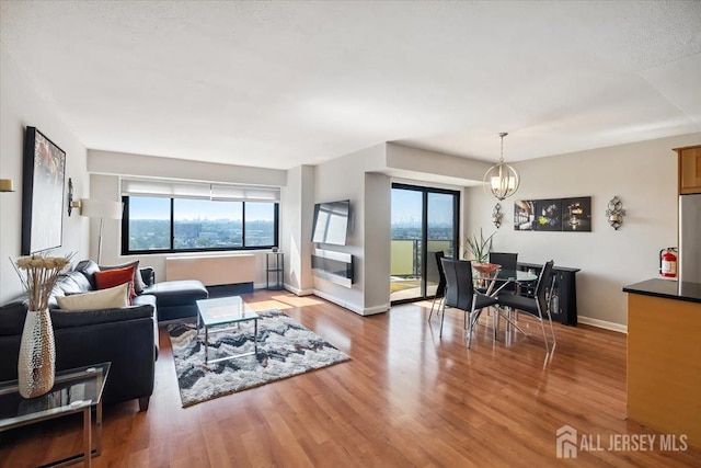 150 Overlook Ave Unit 15E, Hackensack, NJ 07601 - living room with plenty of natural light, wood finished floors, and a chandelier