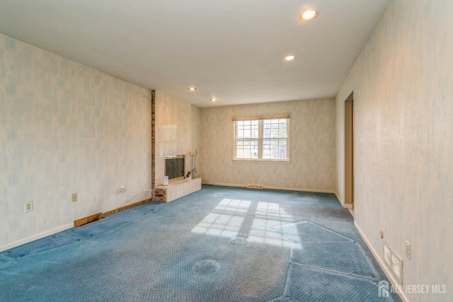 unfurnished living room featuring carpet floors