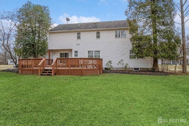 rear view of house featuring a yard and a deck