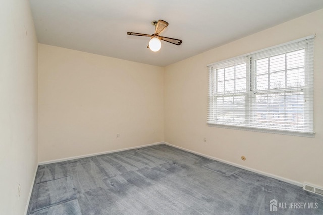 carpeted empty room featuring ceiling fan