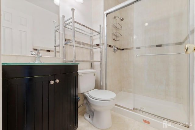 full bathroom featuring tile patterned flooring, a shower stall, toilet, and tile walls