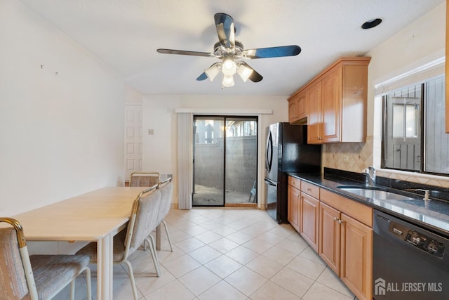 kitchen featuring light tile patterned floors, ceiling fan, decorative backsplash, black appliances, and a sink