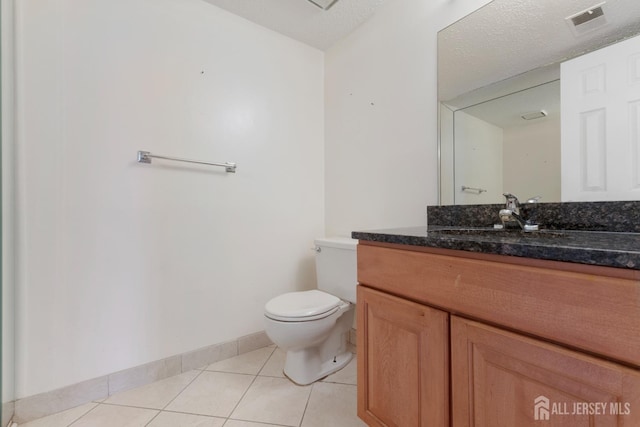 bathroom with tile patterned floors, visible vents, toilet, baseboards, and vanity