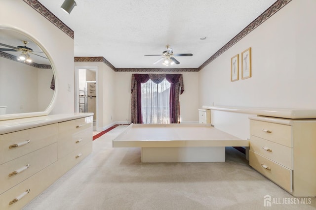 unfurnished bedroom with light colored carpet, a textured ceiling, baseboards, and ornamental molding