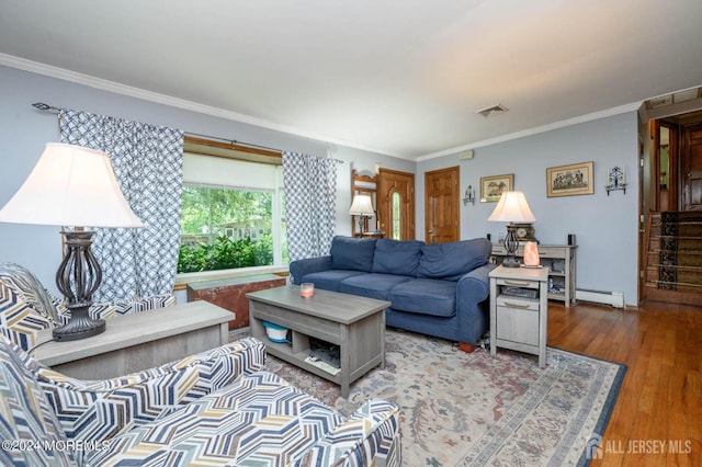 living room with crown molding, hardwood / wood-style floors, and baseboard heating