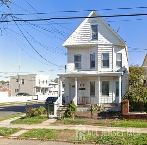 596 Johnstone St, Perth Amboy, NJ 08861 - view of front of home featuring covered porch, a fenced front yard, and a gate