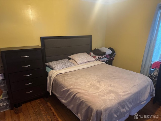 bedroom featuring dark wood-style flooring
