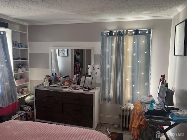bedroom featuring ornamental molding, a textured ceiling, and radiator heating unit