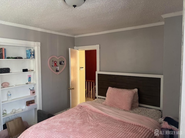 bedroom featuring crown molding and a textured ceiling