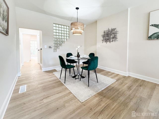 dining space with light wood-type flooring