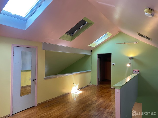 112 Beverly Hill Ter Unit H, Woodbridge Proper, NJ 07095 - empty room with a skylight, lofted ceiling, and wood finished floors