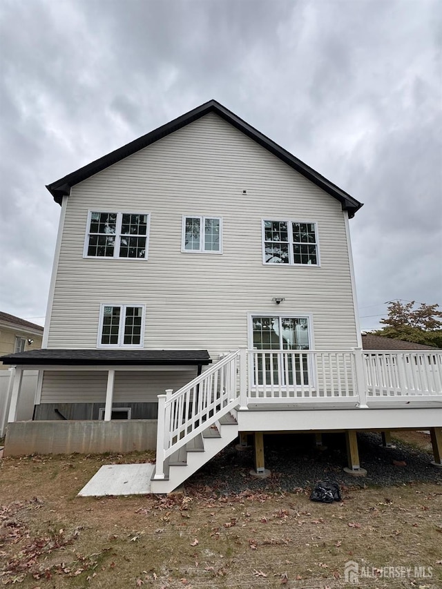 back of house with a wooden deck