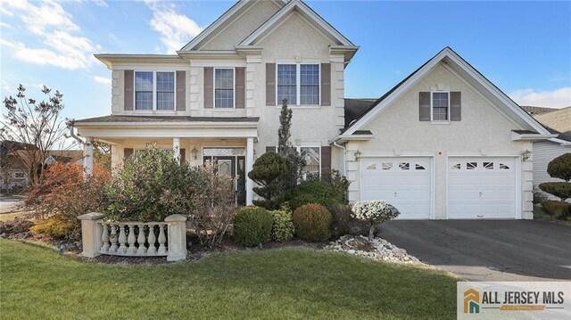 view of front of house with a front yard and a garage