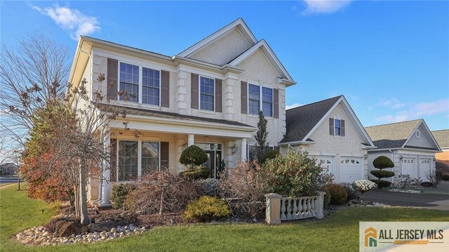 view of front of property with a front lawn and a garage