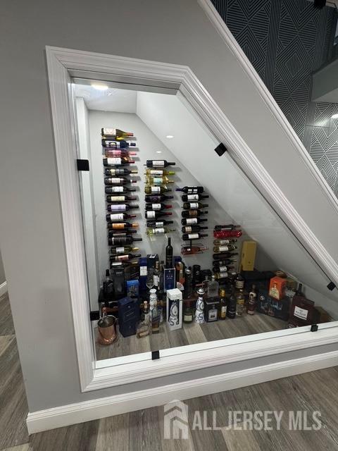 wine room featuring electric panel, dark hardwood / wood-style flooring, and lofted ceiling