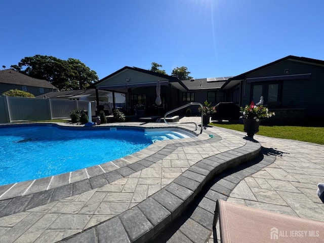 view of swimming pool with a patio area