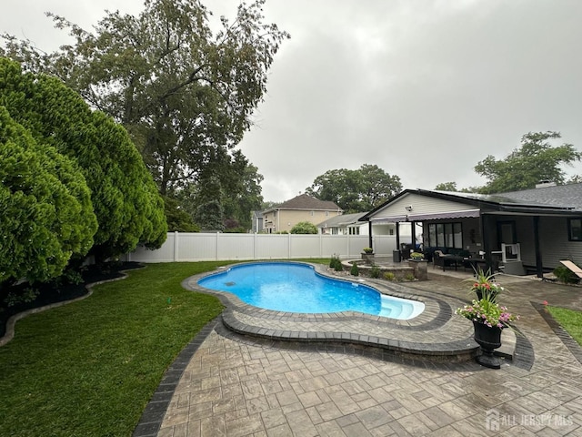 view of swimming pool with a patio and a yard