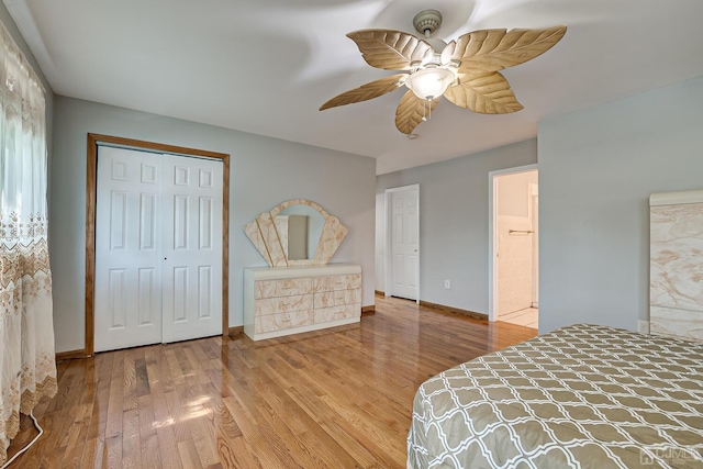 bedroom with a ceiling fan, baseboards, light wood-type flooring, and a closet